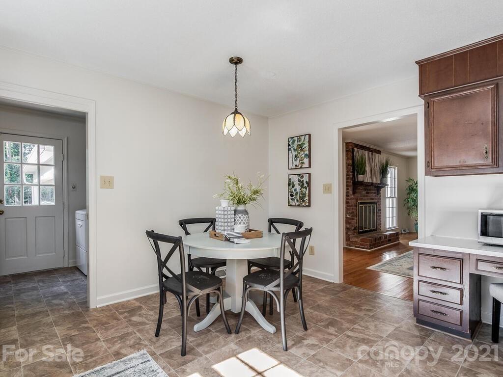 4920 Pine Ridge Road Charlotte, NC 28226 - Photo 10 of 28 a view of a dining room with furniture and wooden floor