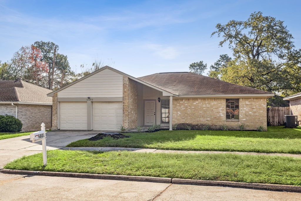 5602 Bridgegate Drive Spring, TX 77373 - Photo 17 of 17 a front view of a house with a yard and garage