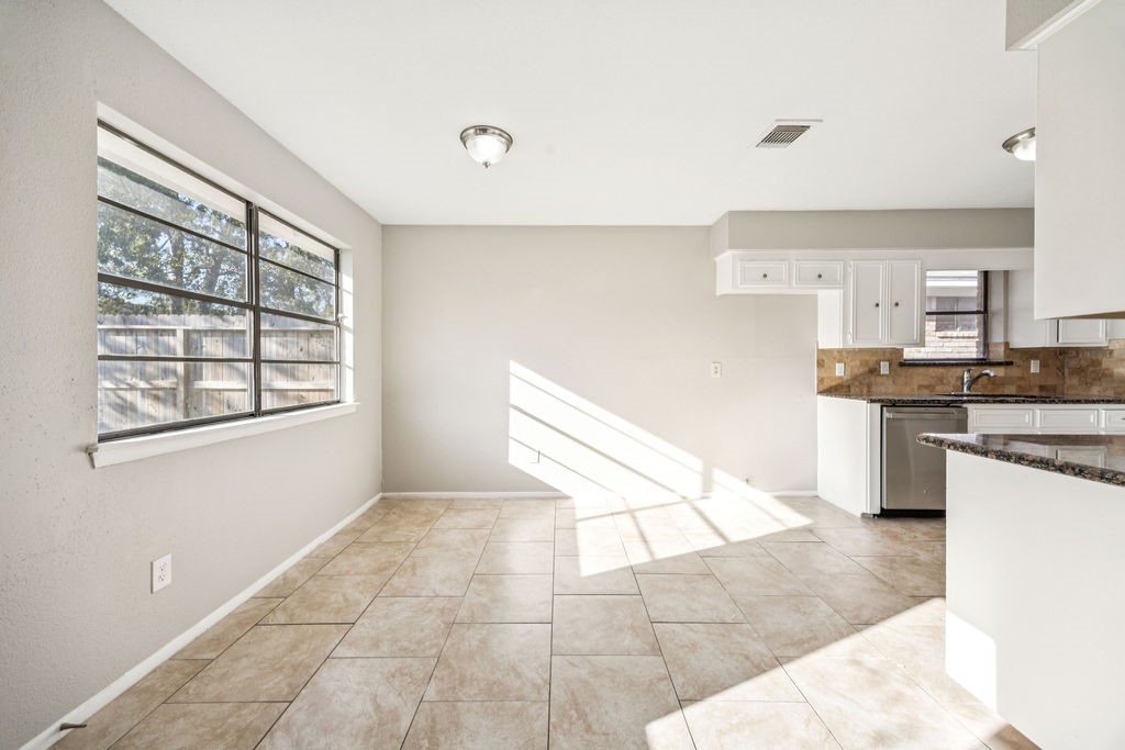 5602 Bridgegate Drive Spring, TX 77373 - Photo 4 of 17 a kitchen with stainless steel appliances granite countertop a stove a sink and a white cabinets