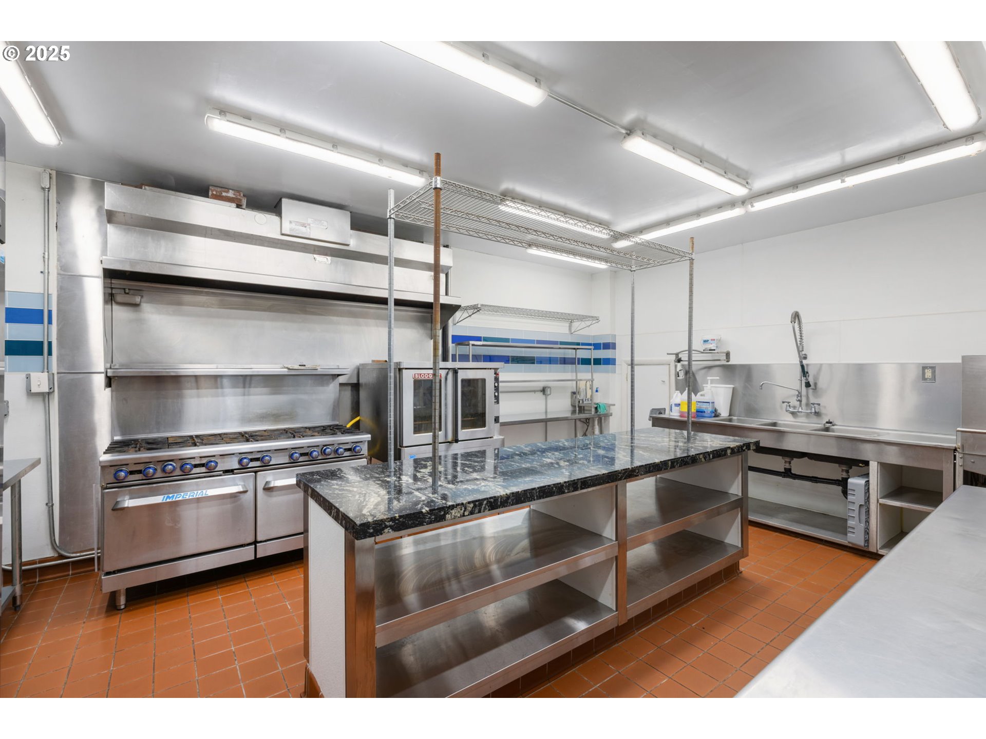 13047 Southeast Ramona Street Portland, OR 97236 - Photo 28 of 48 a kitchen with stainless steel appliances granite countertop a stove a sink and a refrigerator