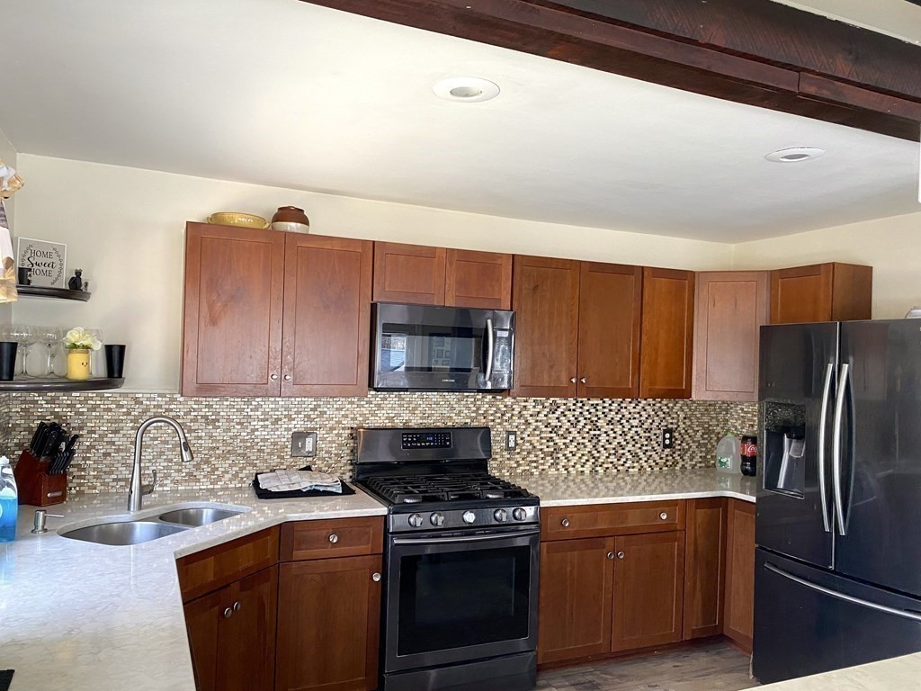 95 Franklin Street Douglas, MA 01516 - Photo 19 of 40 a kitchen with stainless steel appliances granite countertop a stove a sink and a refrigerator