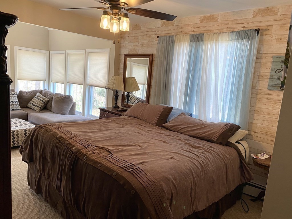 95 Franklin Street Douglas, MA 01516 - Photo 23 of 40 a bedroom with a bed and a chandelier