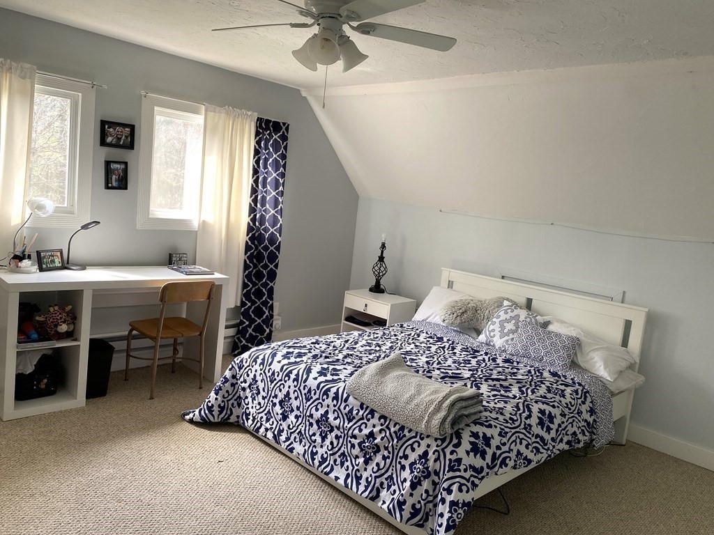 95 Franklin Street Douglas, MA 01516 - Photo 25 of 40 a bedroom with a bed and a chandelier