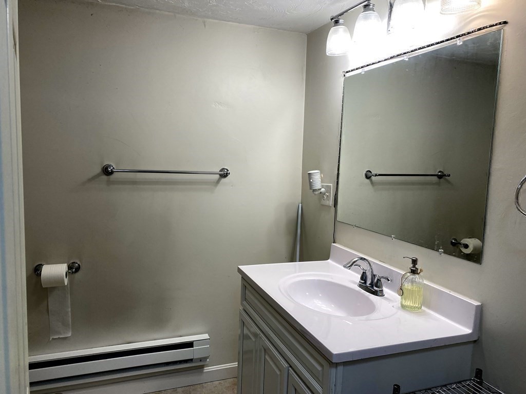 95 Franklin Street Douglas, MA 01516 - Photo 34 of 40 a bathroom with a sink and a mirror