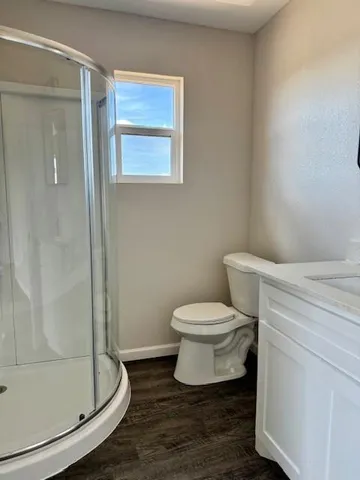 a bathroom with a toilet and a shower