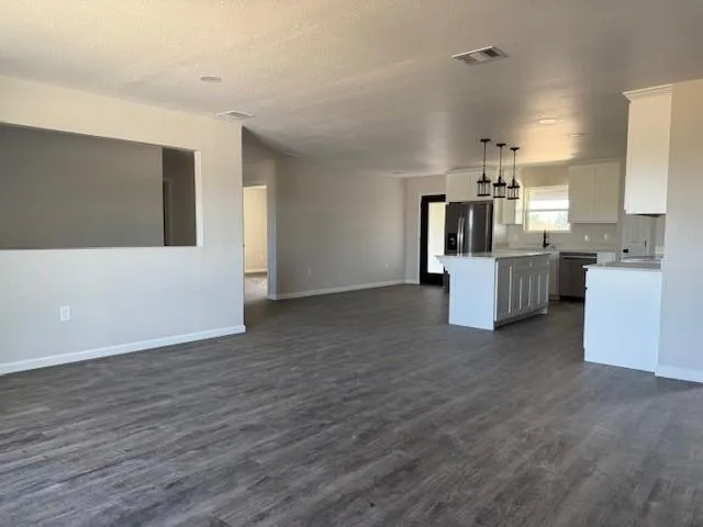 a view of kitchen and kitchen with furniture wooden floor and window