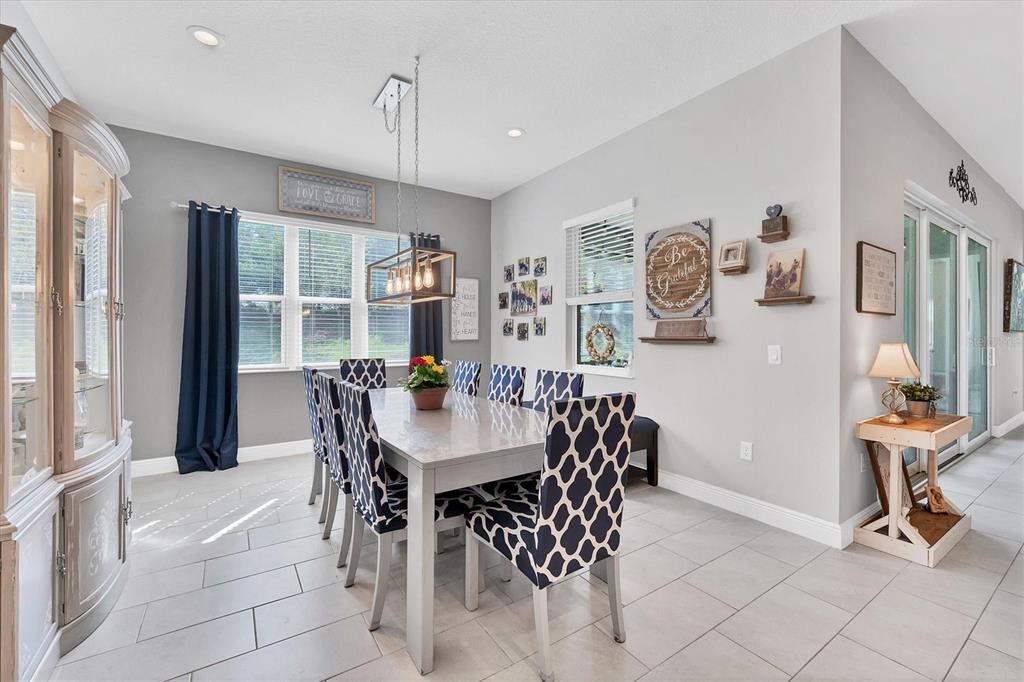 13306 Deep Blue Place Bradenton, FL 34211 - Photo 17 of 73 a view of a dining room with furniture and chandelier
