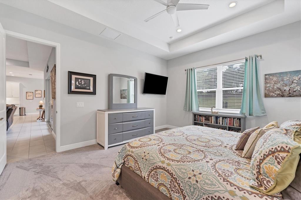 13306 Deep Blue Place Bradenton, FL 34211 - Photo 22 of 73 a bedroom with a bed and a flat screen tv