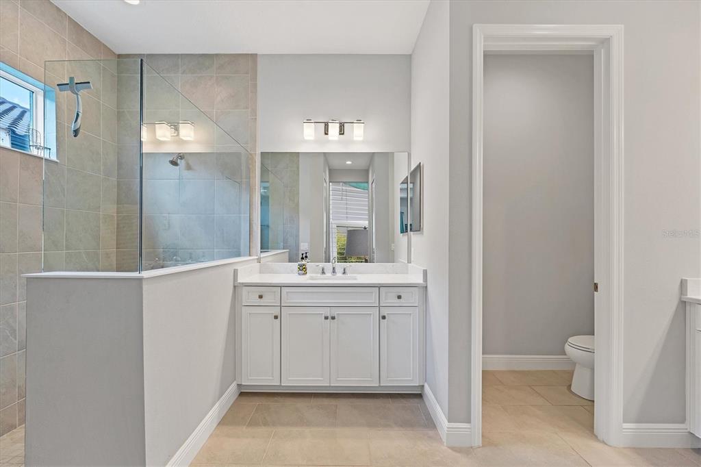 13306 Deep Blue Place Bradenton, FL 34211 - Photo 23 of 73 a spacious bathroom with a granite countertop sink and a mirror