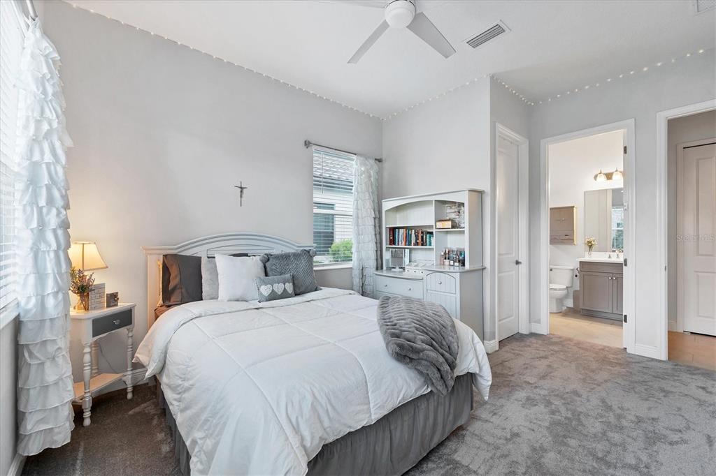 13306 Deep Blue Place Bradenton, FL 34211 - Photo 29 of 73 a spacious bedroom with a bed and a walk in closet