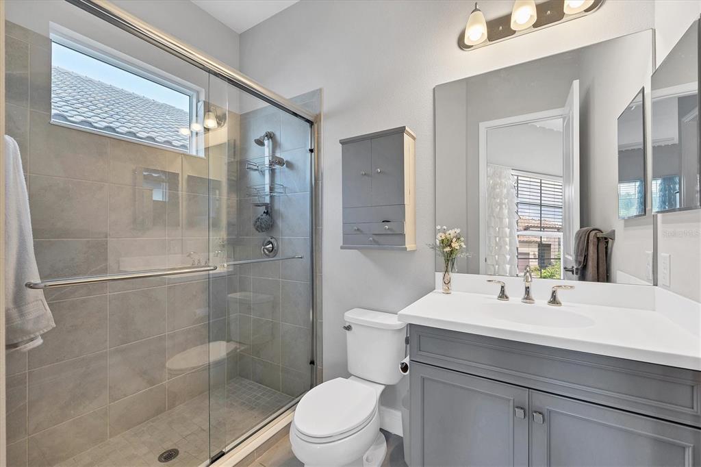 13306 Deep Blue Place Bradenton, FL 34211 - Photo 30 of 73 a bathroom with a sink mirror toilet and shower