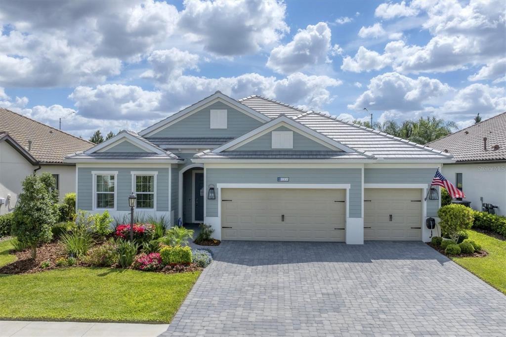 13306 Deep Blue Place Bradenton, FL 34211 - Photo 48 of 73 a view of a house with a yard and a garage