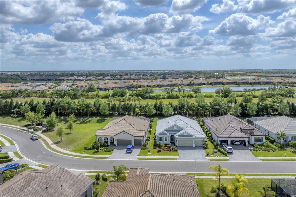 13306 Deep Blue Place Bradenton, FL 34211 - Photo 50 of 73 an aerial view of a house with a garden and lake view