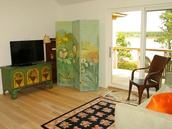 a living room with a flat screen tv and a floor to ceiling window