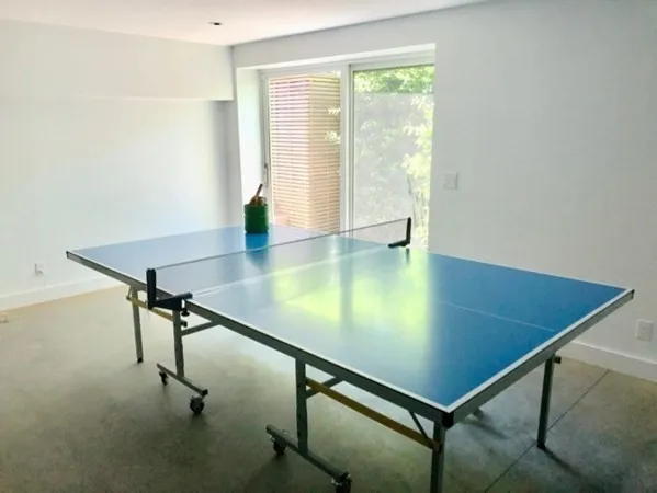 a room with pool table and windows