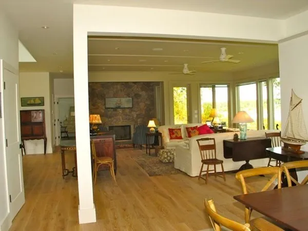 a living room with furniture dining table and a large window