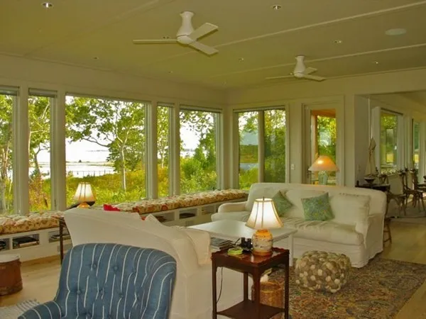 a living room with furniture and large windows