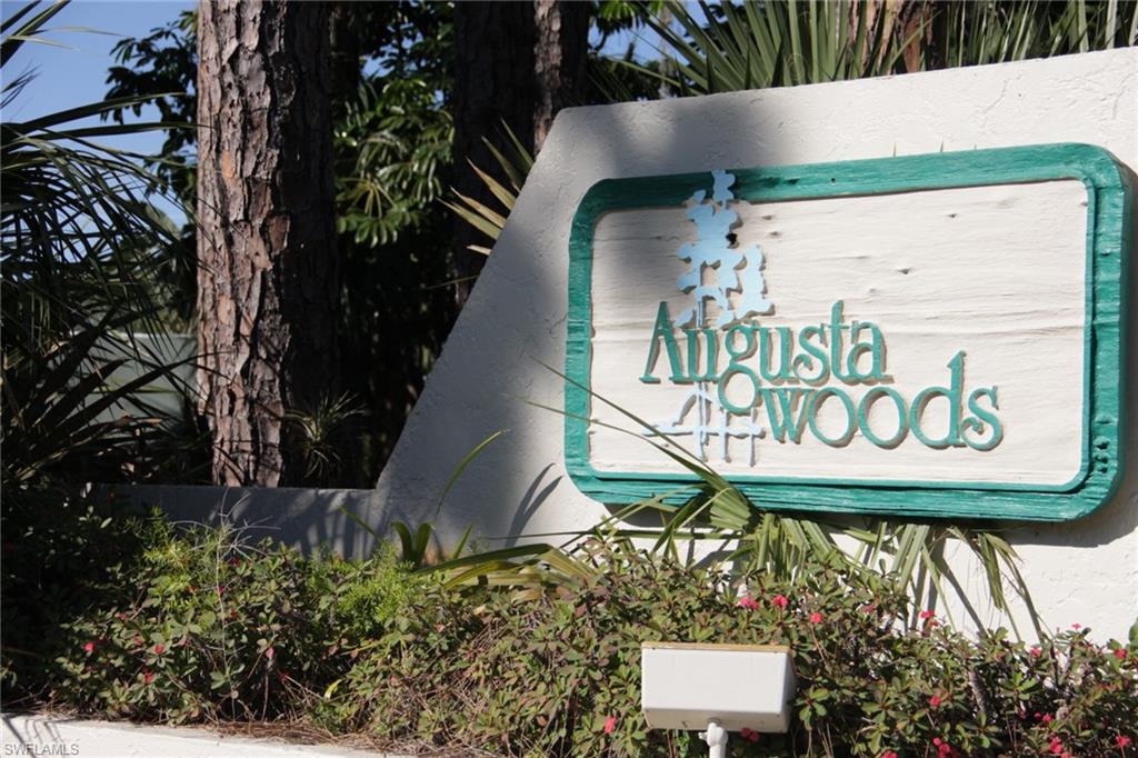 5841 Rattlesnake Hammock Road, Unit I206 Naples, FL 34113 - Photo 1 of 24 a sign on the side of a building
