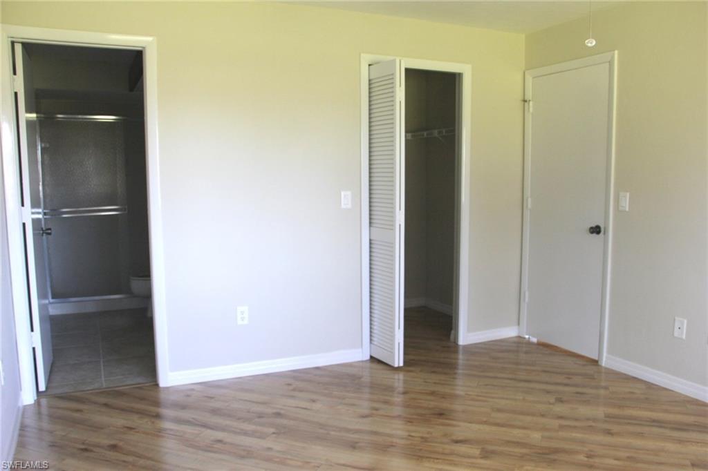 5841 Rattlesnake Hammock Road, Unit I206 Naples, FL 34113 - Photo 11 of 24 a view of an empty room with closet and wooden floor