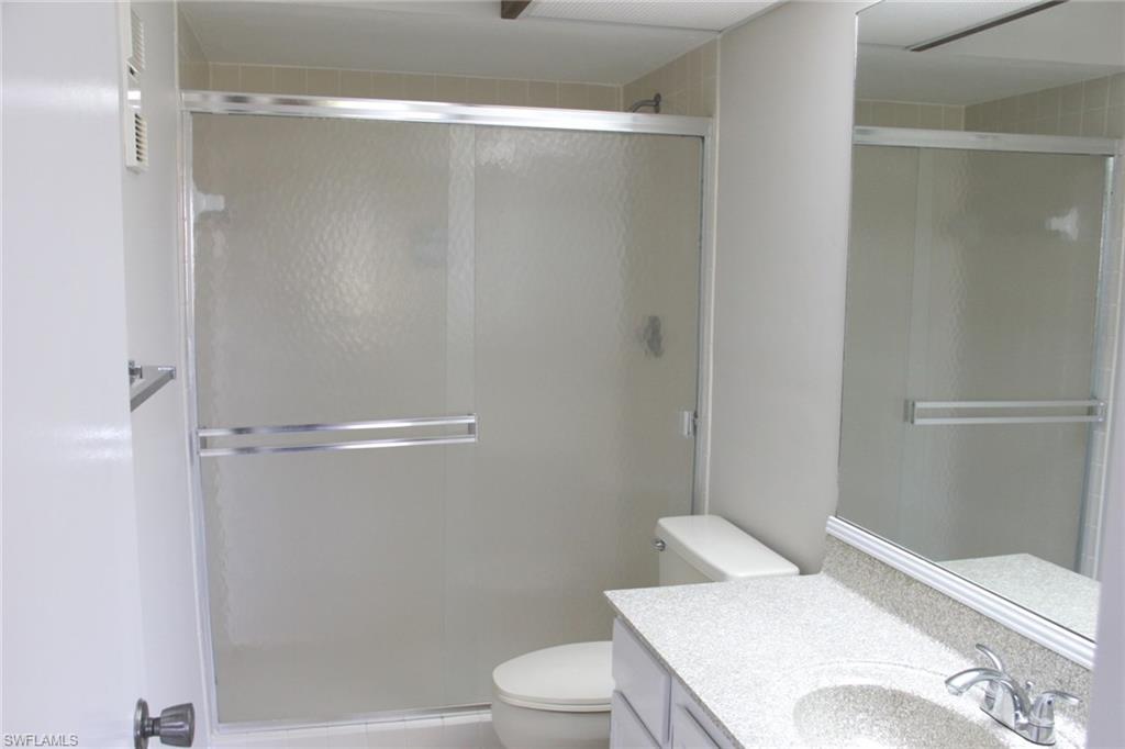 5841 Rattlesnake Hammock Road, Unit I206 Naples, FL 34113 - Photo 13 of 24 a bathroom with a sink a toilet and shower