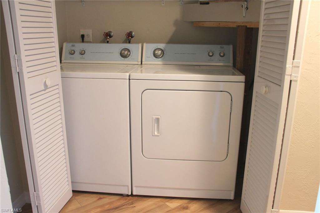 5841 Rattlesnake Hammock Road, Unit I206 Naples, FL 34113 - Photo 14 of 24 a utility room with dryer and washer