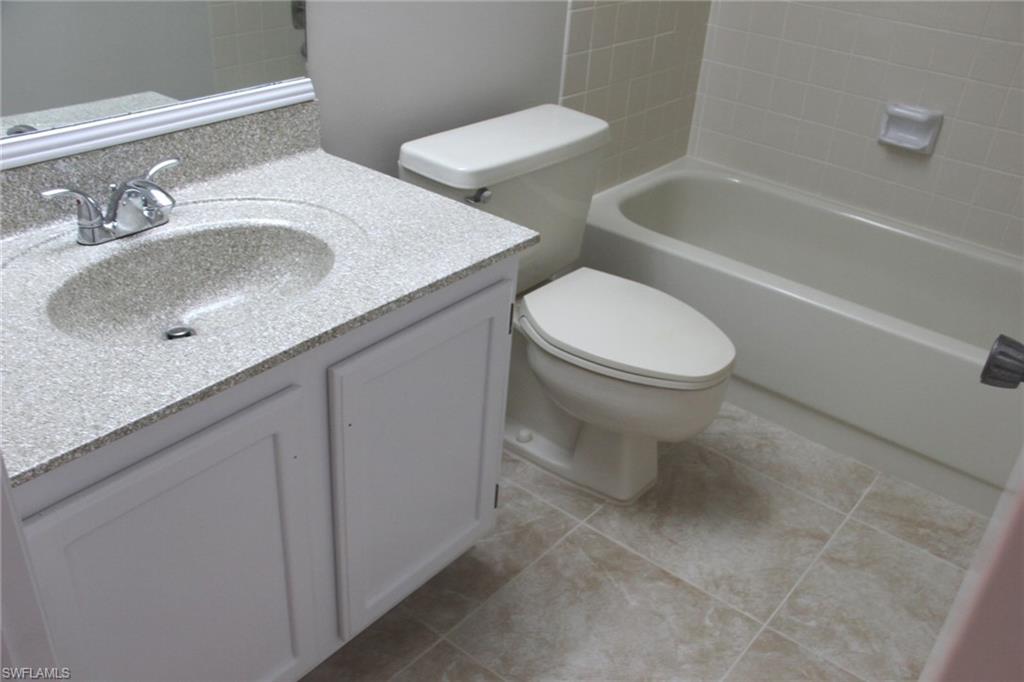 5841 Rattlesnake Hammock Road, Unit I206 Naples, FL 34113 - Photo 15 of 24 a bathroom with a sink and toilet