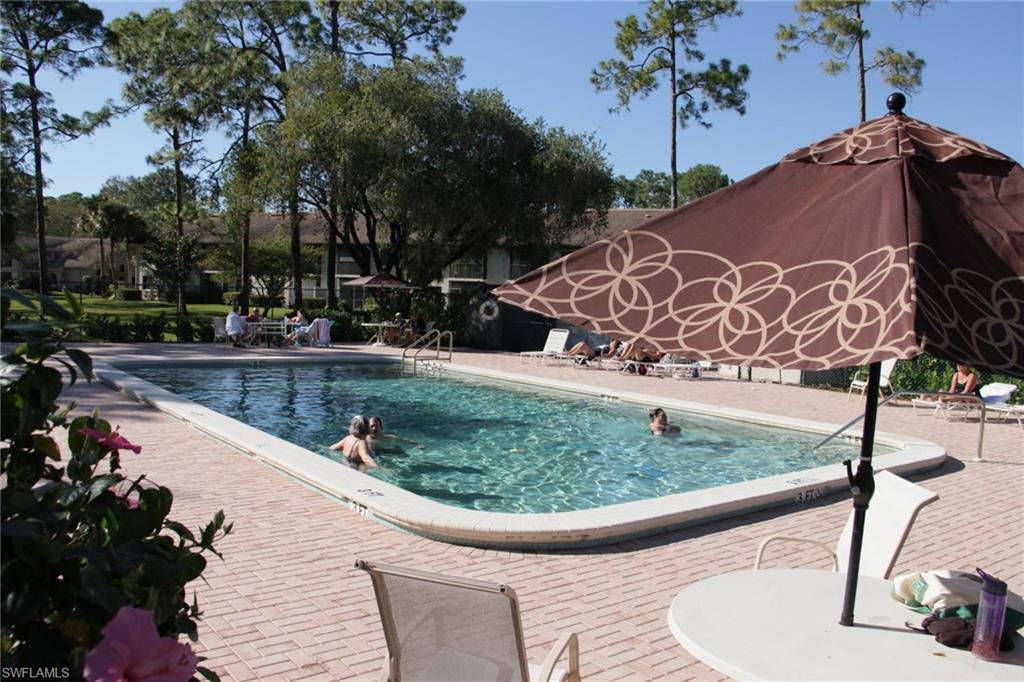5841 Rattlesnake Hammock Road, Unit I206 Naples, FL 34113 - Photo 21 of 24 a view of a swimming pool with a patio