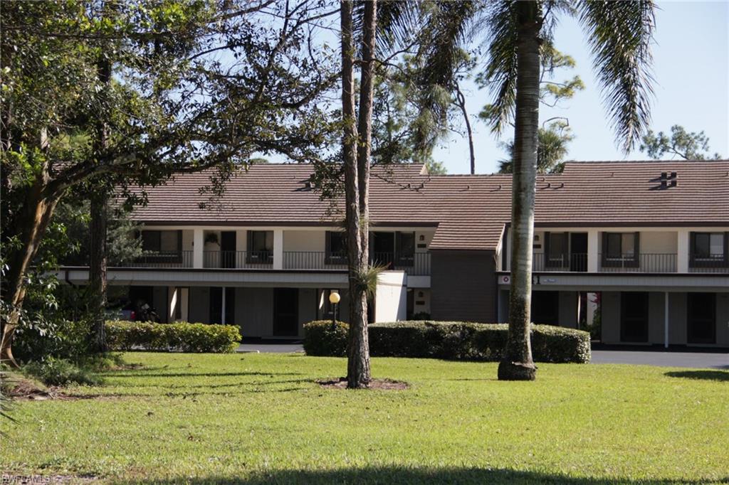 5841 Rattlesnake Hammock Road, Unit I206 Naples, FL 34113 - Photo 23 of 24 a front view of a house with a yard