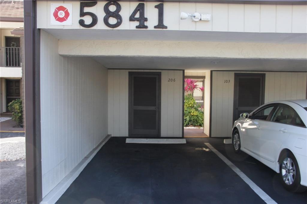 5841 Rattlesnake Hammock Road, Unit I206 Naples, FL 34113 - Photo 3 of 24 a view of a car garage door