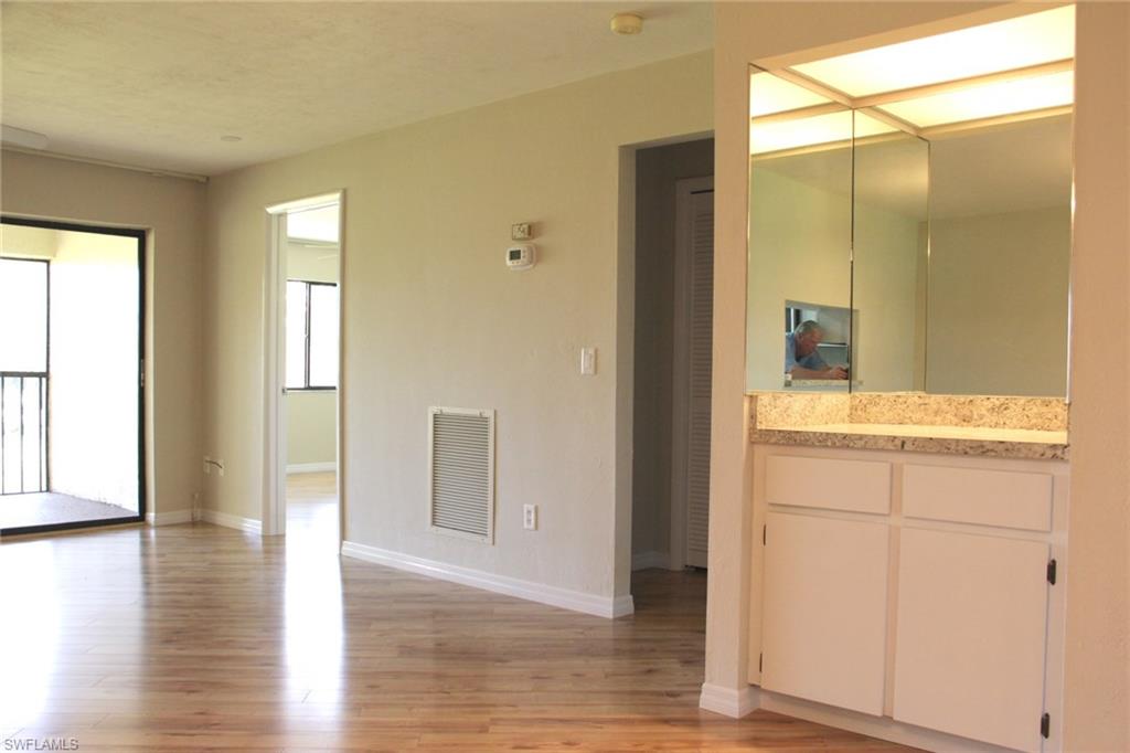 5841 Rattlesnake Hammock Road, Unit I206 Naples, FL 34113 - Photo 10 of 24 a bathroom with a glass door shower a sink and a mirror