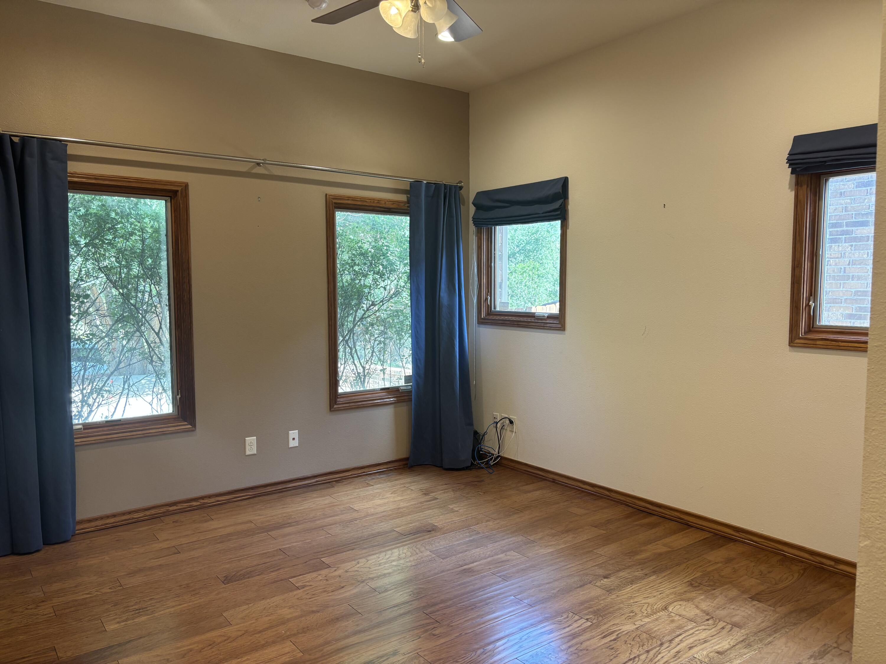 33 West Lakeshore Drive Ransom Canyon, TX 79366 - Photo 37 of 48 an empty room with wooden floor and windows