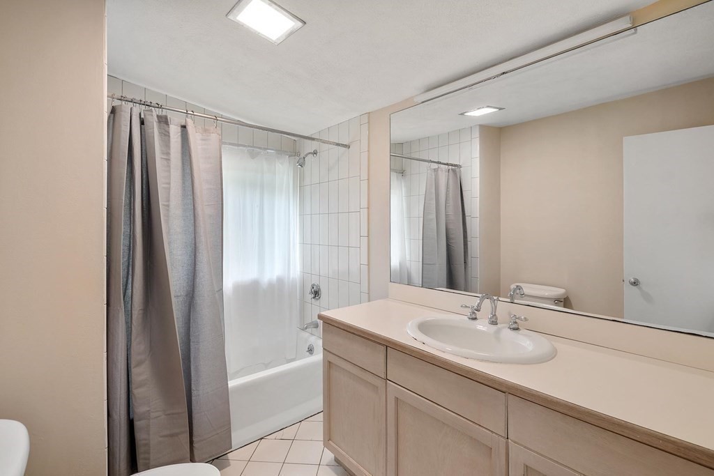 32 Peacock Farm Road Lexington, MA 02421 - Photo 11 of 16 a bathroom with a granite countertop sink a shower and a mirror