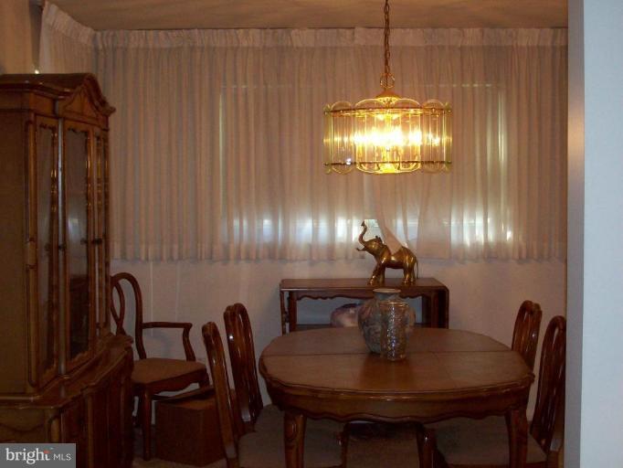 7109 Boxford Road Baltimore, MD 21215 - Photo 3 of 6 a dining room with furniture and chandelier