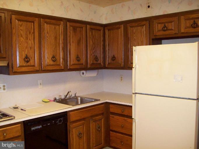 7109 Boxford Road Baltimore, MD 21215 - Photo 6 of 6 a kitchen with stainless steel appliances granite countertop a refrigerator and a sink