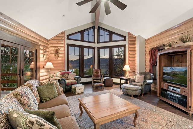 12465 Bone Road Kamas, UT 84036 - Photo 15 of 63 Vaulted ceiling with a ceiling fan, log-style wall finishes, a wall of windows, French doors, and wood-finish flooring