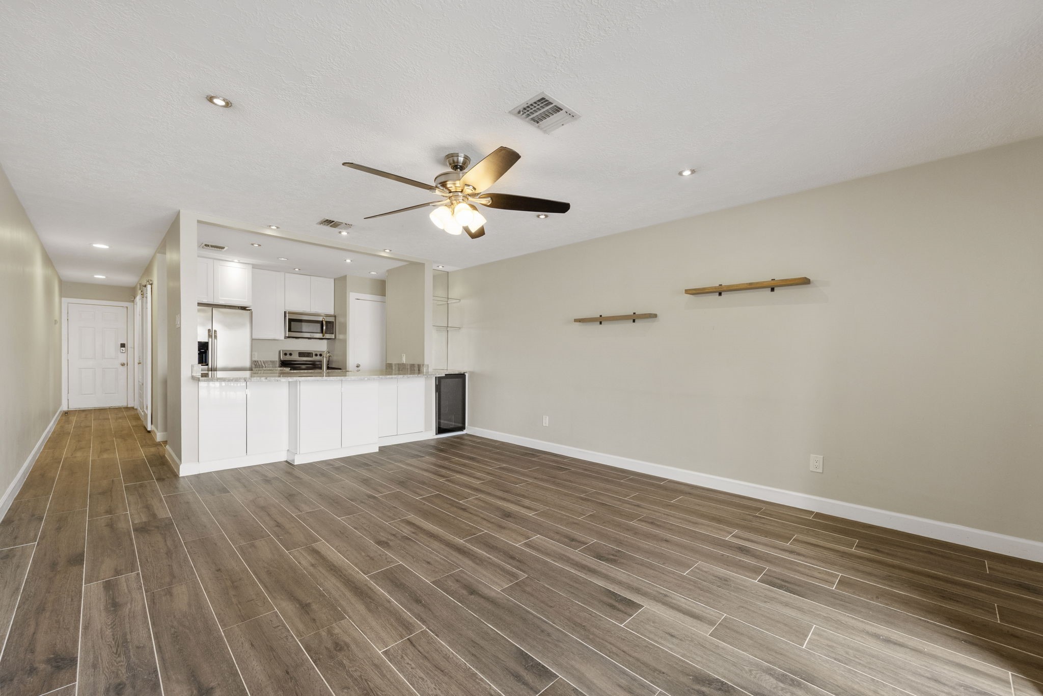 801 River Road, Unit 105C Montgomery, TX 77356 - Photo 6 of 30 Enjoy modern updates, wood-look tile throughout, and warm neutral tones that create a bright and inviting living space.