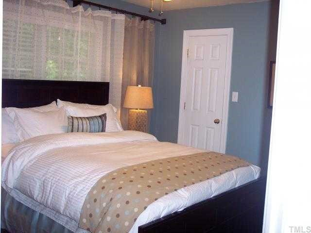 5824 Ventry Court Raleigh, NC 27613 - Photo 10 of 12 Your guests will feel like they are at a 5-star hotel in this bedroom. Large walk in closet, oak hardwood floors and custom paint. Spacious and inviting! Bedroom