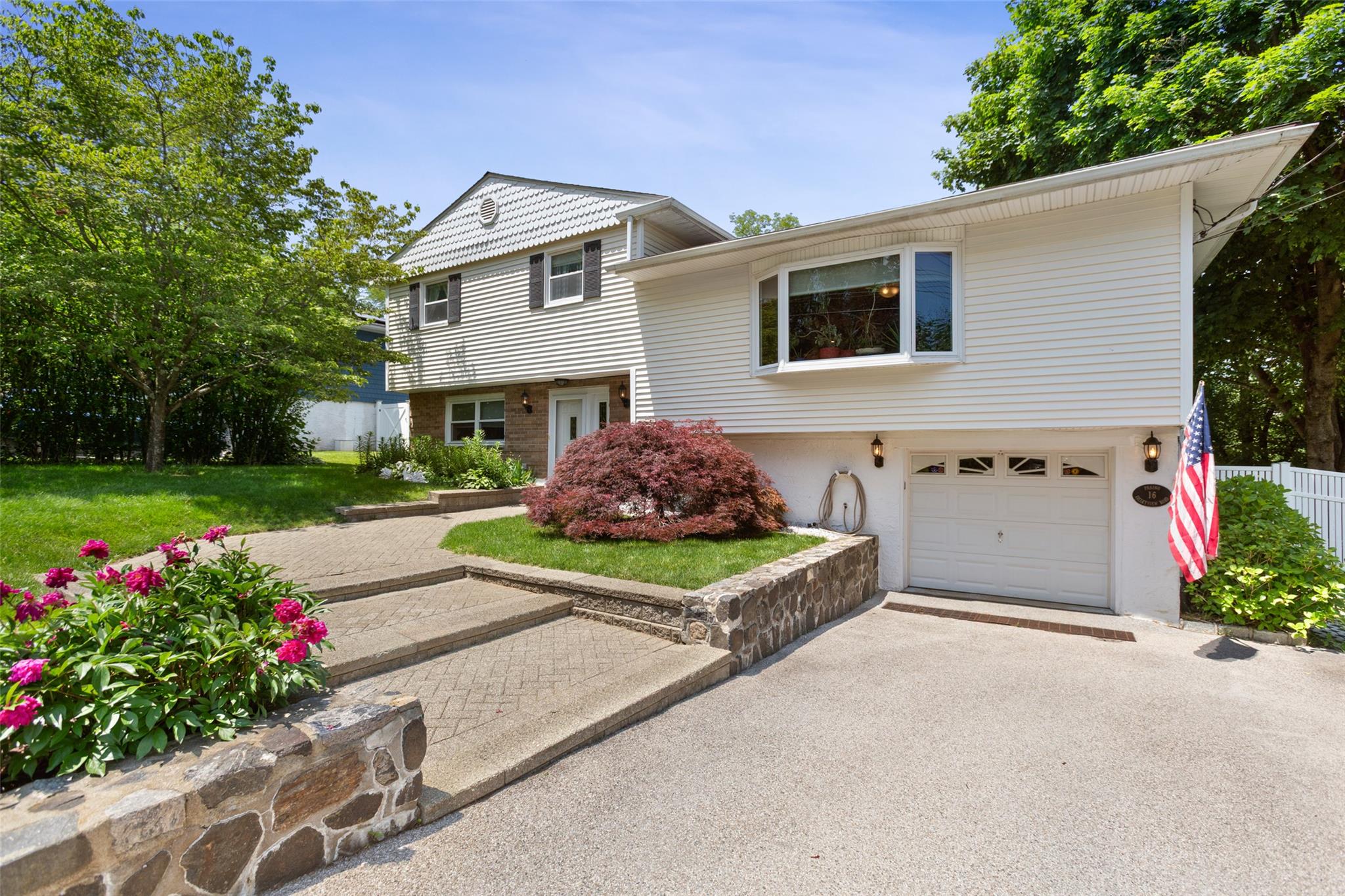 a front view of a house with a yard and garage
