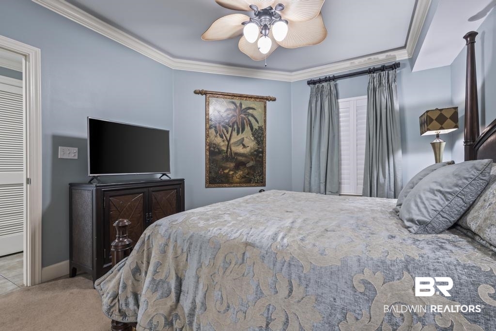 27582 Canal Road, Unit 2408 Orange Beach, AL 36561 - Photo 22 of 47 Bedroom featuring ceiling fan, crown molding, and carpet
