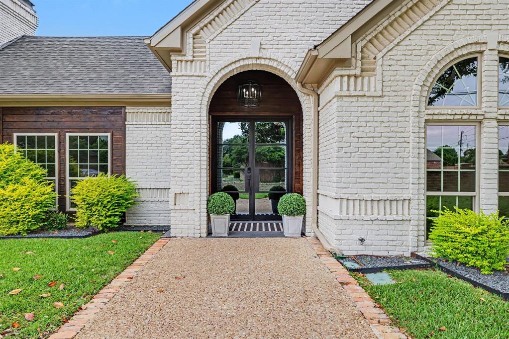 17327 Davenport Road Dallas, TX 75248 - Photo 13 of 40 a front view of a house with a garden