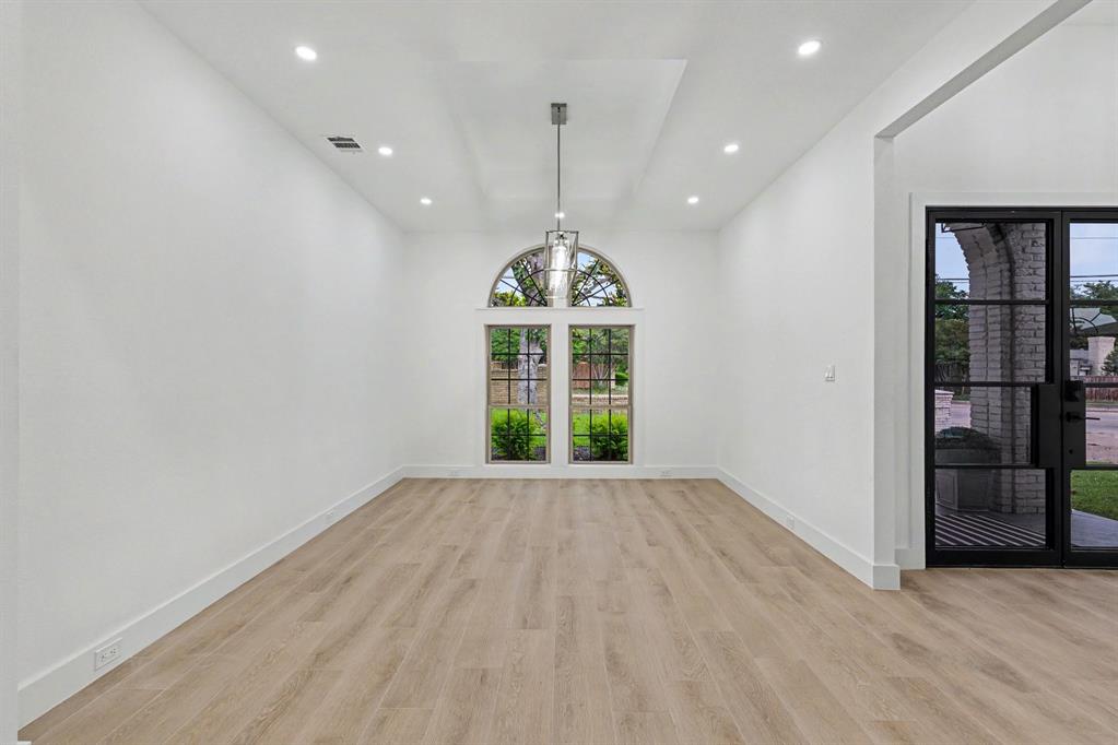 17327 Davenport Road Dallas, TX 75248 - Photo 15 of 40 a view of an empty room with window and hardwood floor