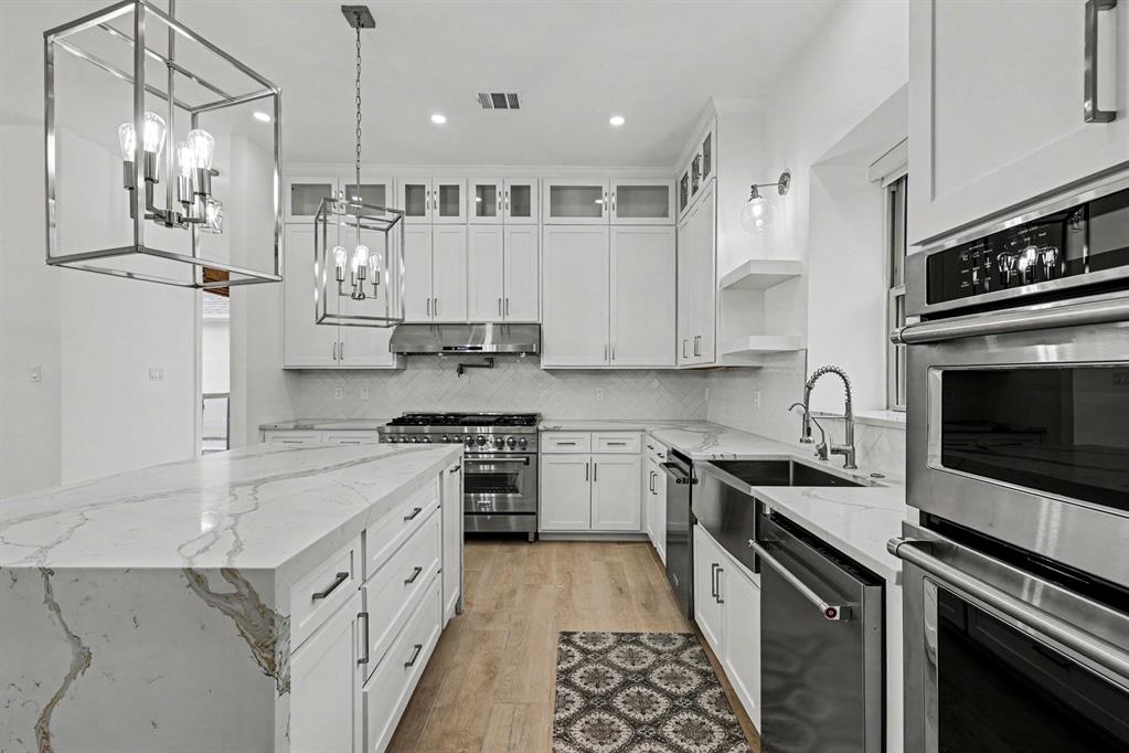 17327 Davenport Road Dallas, TX 75248 - Photo 20 of 40 a kitchen with stainless steel appliances granite countertop a stove a sink and a refrigerator