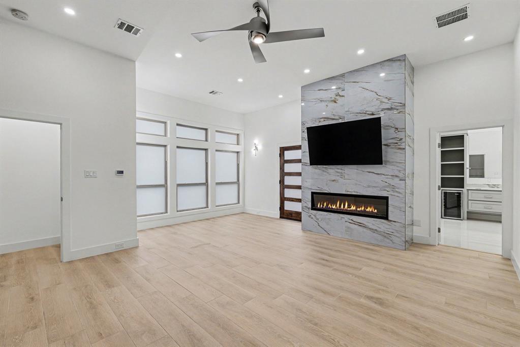 17327 Davenport Road Dallas, TX 75248 - Photo 24 of 40 a view of a livingroom with a flat screen tv and fireplace