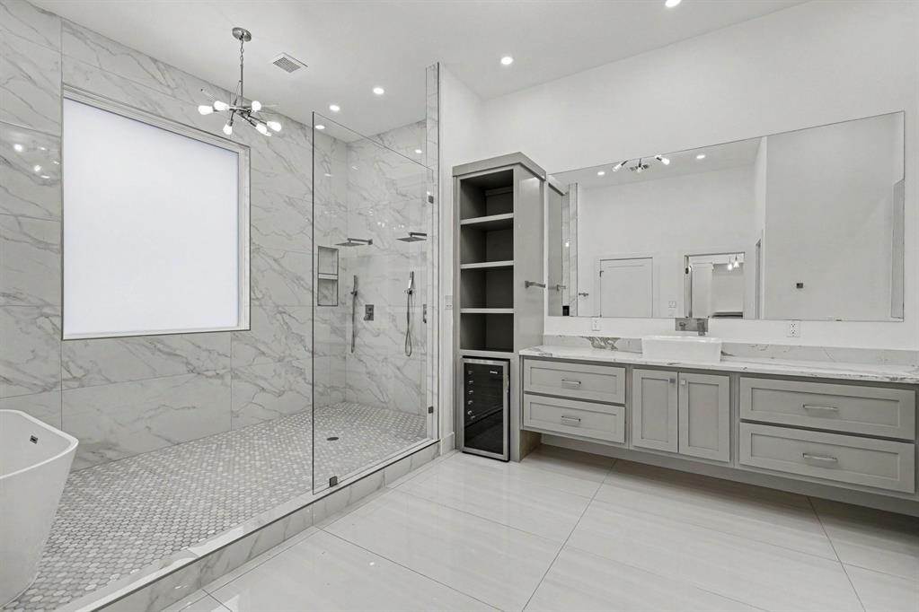 17327 Davenport Road Dallas, TX 75248 - Photo 26 of 40 a bathroom with a double vanity sink mirror and shower