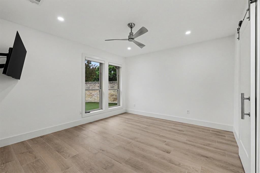 17327 Davenport Road Dallas, TX 75248 - Photo 30 of 40 an empty room with windows and cabinet