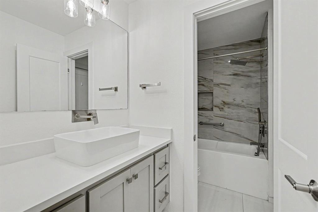 17327 Davenport Road Dallas, TX 75248 - Photo 31 of 40 a bathroom with a sink and a mirror