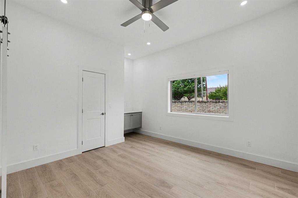 17327 Davenport Road Dallas, TX 75248 - Photo 32 of 40 an empty room with a window and a ceiling fan