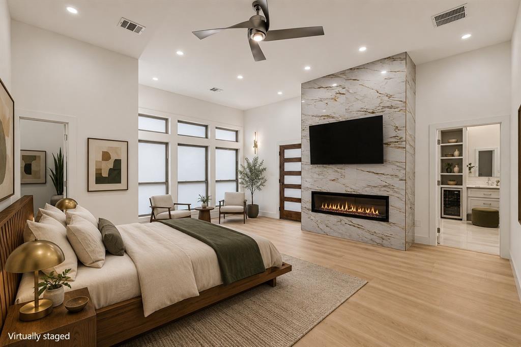 17327 Davenport Road Dallas, TX 75248 - Photo 9 of 40 a spacious bedroom with a bed and a flat screen tv