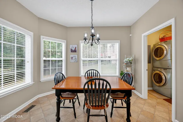 a view of a dining room with furniture wooden floor and chandelier