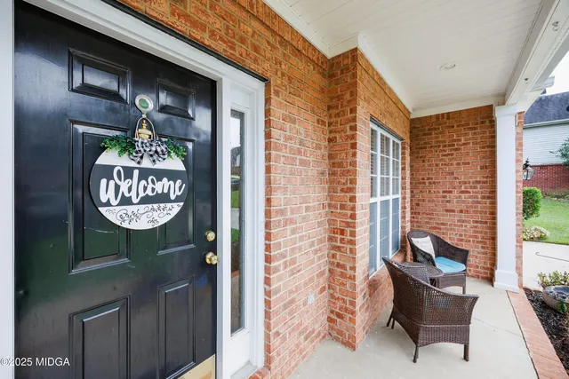 a front view of a house with outdoor seating